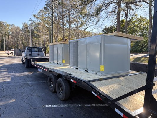 Two 10-ton commercial HVAC units being delivered to the job site